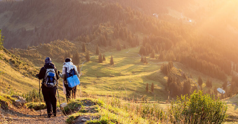 Hikers On Mountain Trail At Sunrise